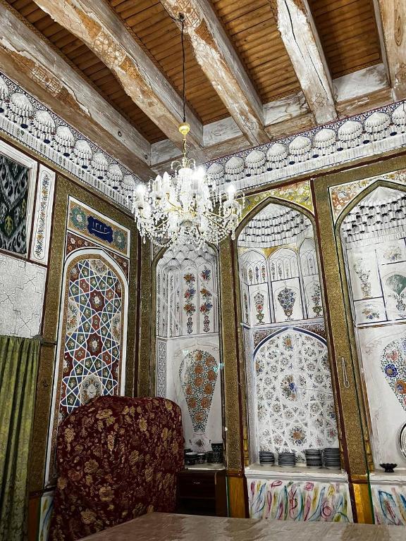 a room with a chandelier and stained glass windows at Hotel Zukhritdin in Bukhara