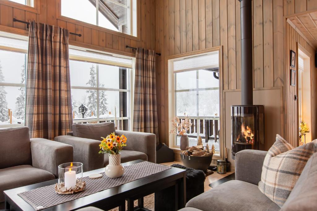 a living room with couches and a fireplace at Flott utsikt Peis Elbillader in Aurdal