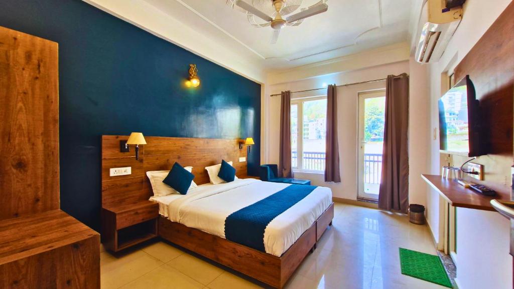 a bedroom with a bed and a blue wall at Haven On Hill - Rishikesh in Rishīkesh