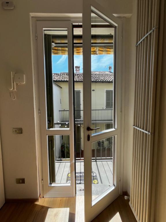 a door to a balcony with a view of a building at P4 Crema Home in Crema
