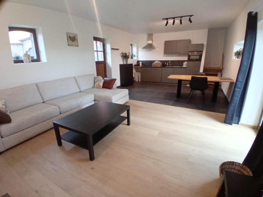 a living room with a couch and a table at Ferme de la Naverie wi - holiday home for 2 persons in Celles