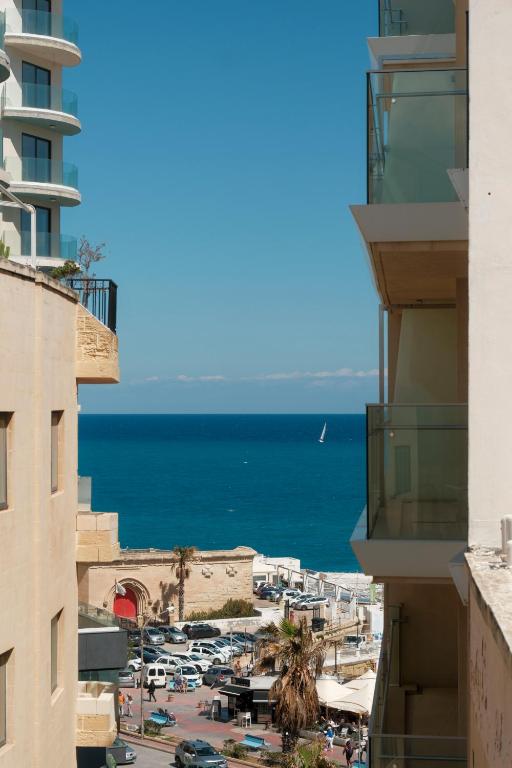 a view of the ocean from between buildings at The 501 by Shmoo in Sliema