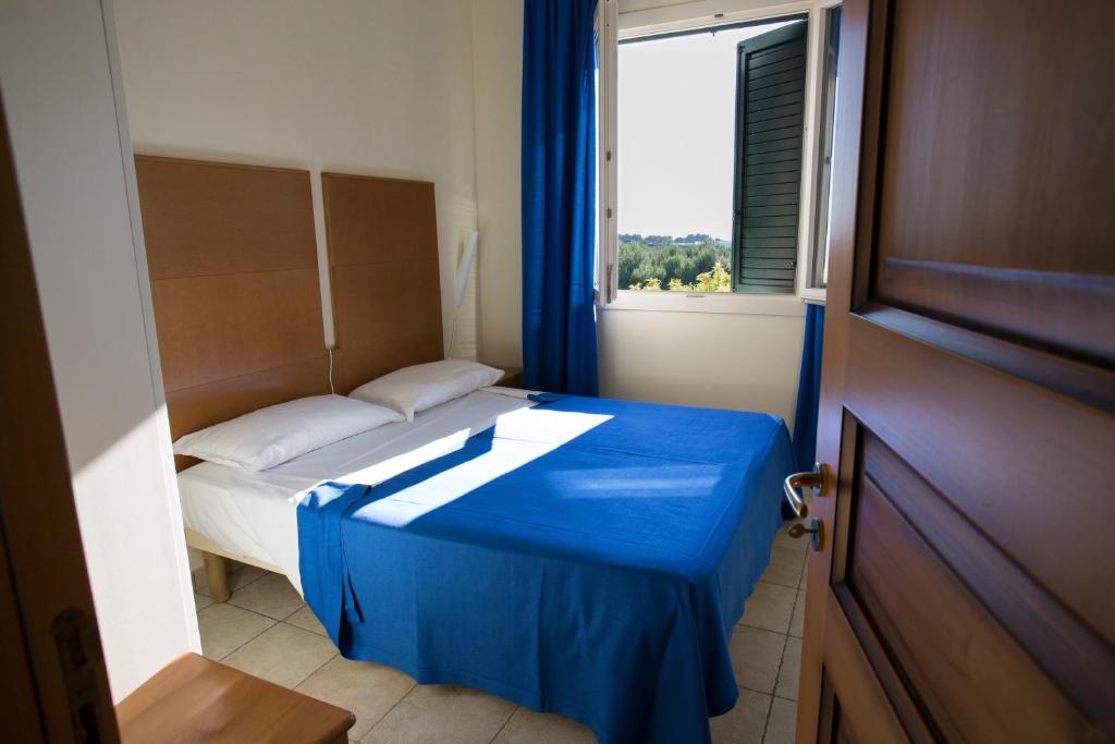 Postel nebo postele na pokoji v ubytování Hotel Resort Portoselvaggio