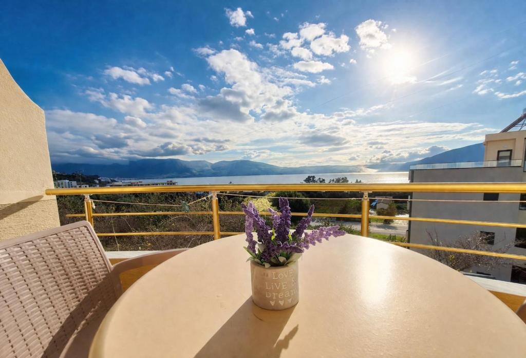 a vase of flowers sitting on a table on a balcony at Mermaid Hotel Vlore in Vlorë