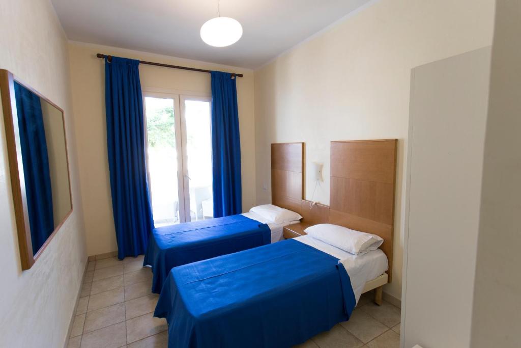 Postel nebo postele na pokoji v ubytování Hotel Resort Portoselvaggio