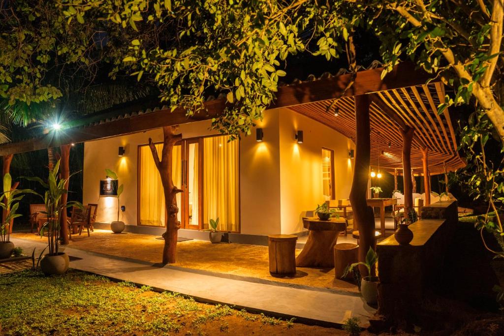 a house with a patio at night at Zov Wild Yala in Kataragama