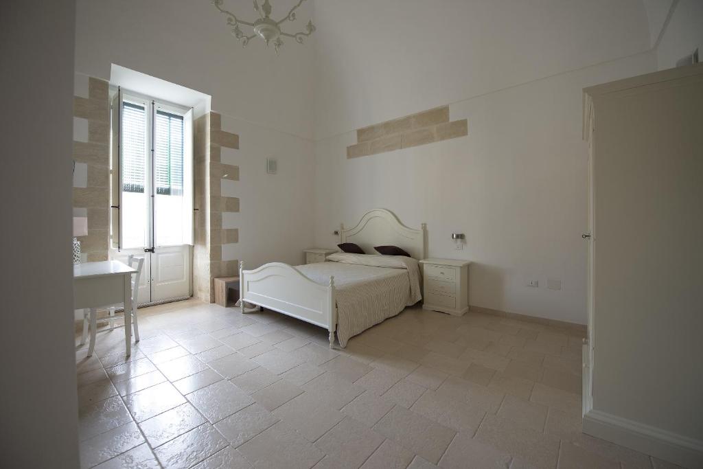 Postel nebo postele na pokoji v ubytování Palazzo Vilei