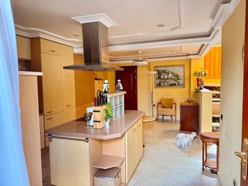 a kitchen with yellow walls and a stove top oven at Villa Tenerife Sur in Adeje