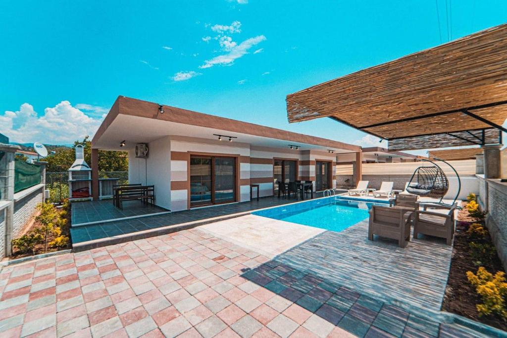 a backyard with a swimming pool and a house at VİLLA Terasa in Fethiye