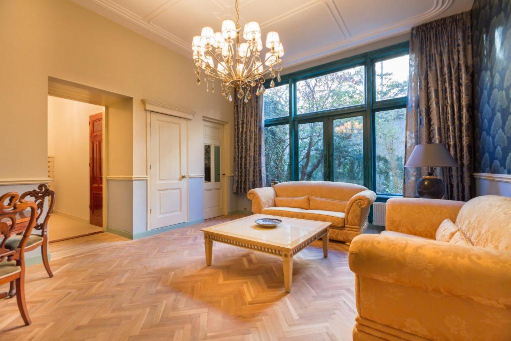 a living room with a couch and a table at The Royal Suite II - R.Q.C. in The Hague