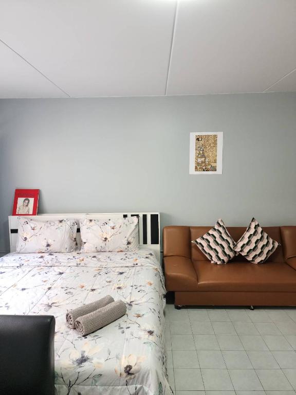 a bedroom with a bed and a couch at Lovely Impact C3-C9 Lily in Nonthaburi