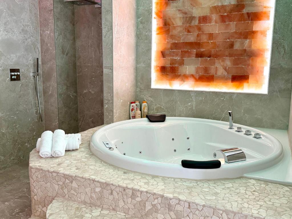 a bathroom with a large tub in a room at Salt Spa de Panne center in De Panne