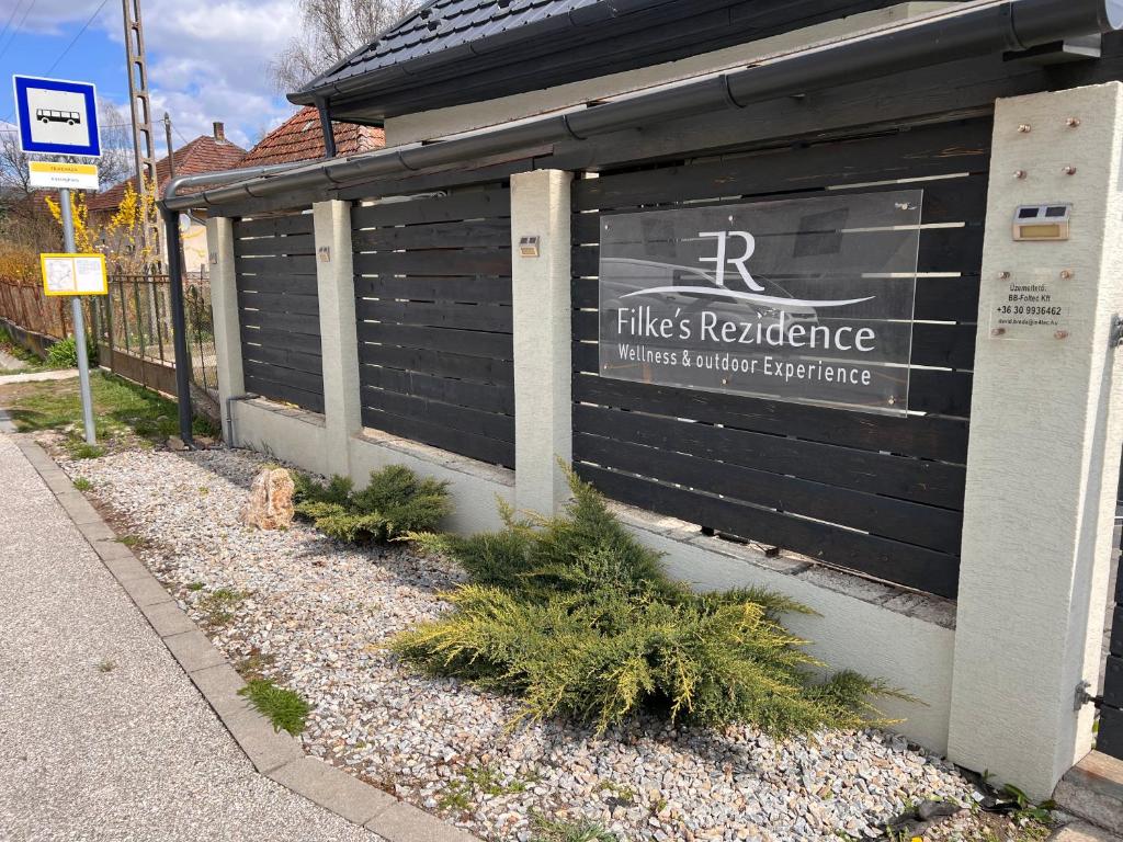 a building with a sign on the side of it at Filkes Rezidence in Filkeháza