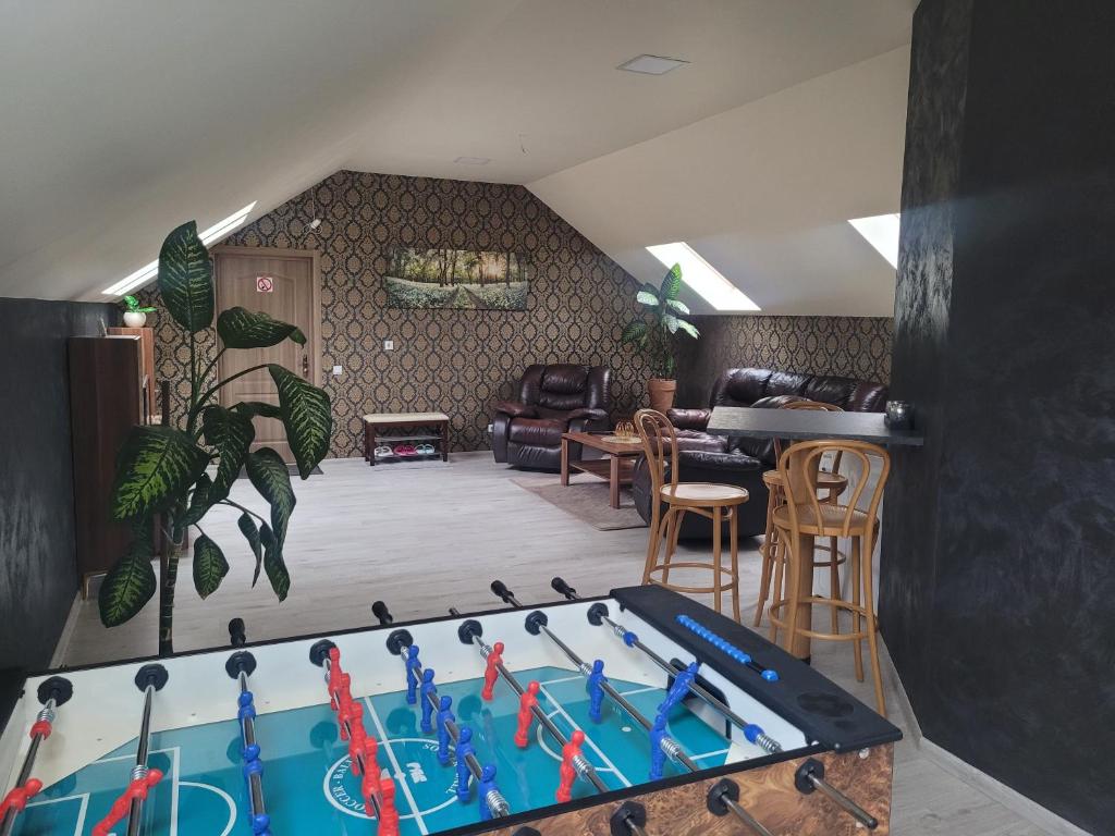 a living room with a pool table in the middle at Apartamentai Rimkuose in Klaipėda