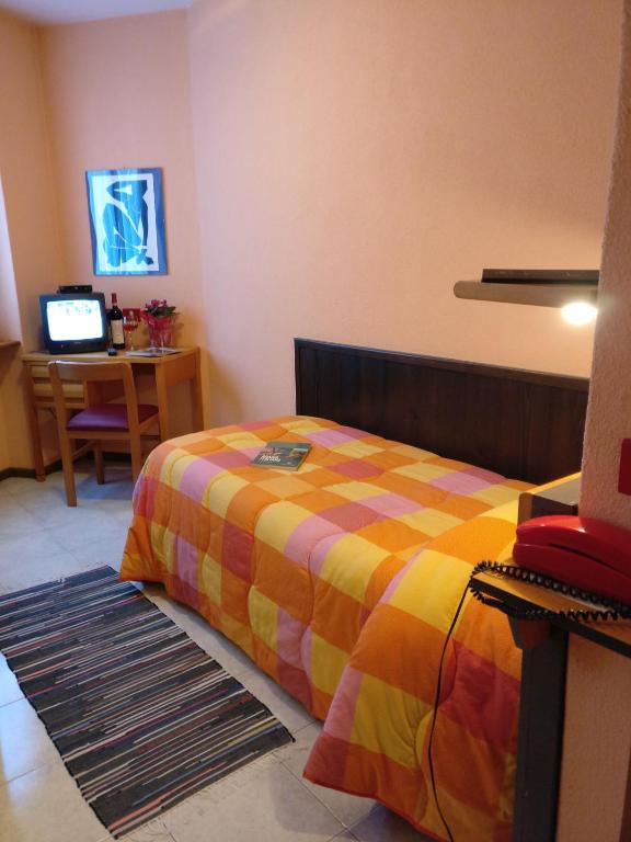 Postel nebo postele na pokoji v ubytování Hotel La Lanterna