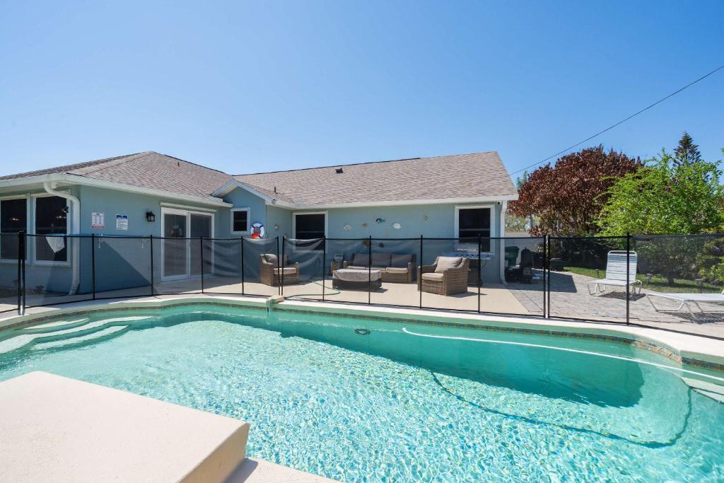 a swimming pool in front of a house at Spacious 5BR Pool Oasis Near Disney Resort in Sebastian