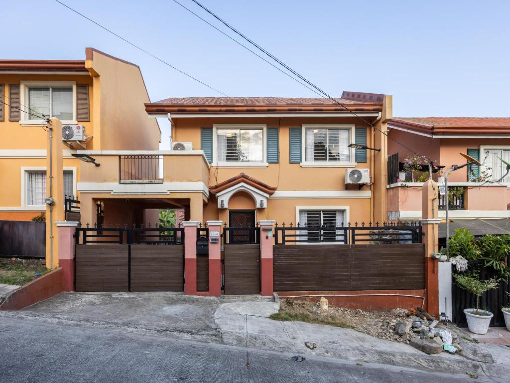 a house with a wooden fence in front of it at Bella Casa (3BR House at Azienda Genova) in Talisay