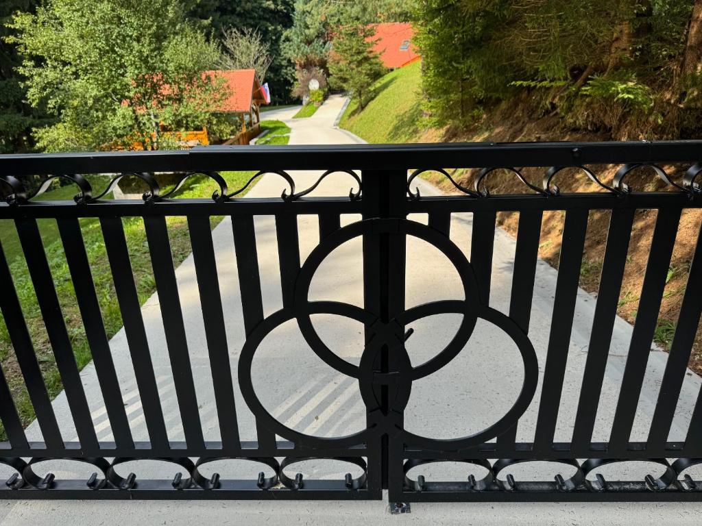 a black iron fence with a walkway at Apartment Rogla Lodge in Zreče