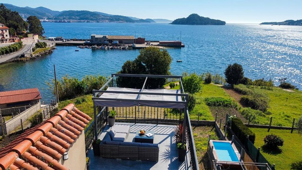 a house with a view of a body of water at Mirador de Tambo - Campelo in Poio