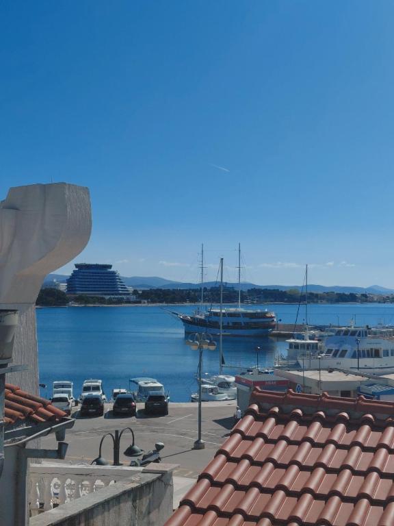 a view of a harbor with a cruise ship in the water at Apartments and room Maressa Centar in Vodice