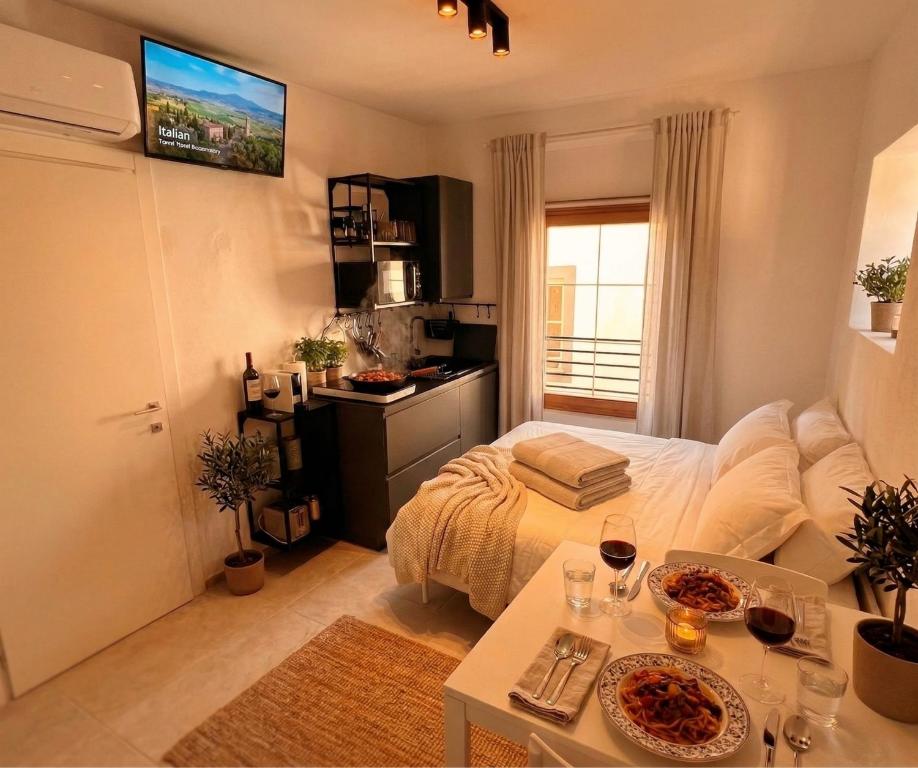 a room with a bed and a table with wine glasses at Centro Storico di Merano in Merano