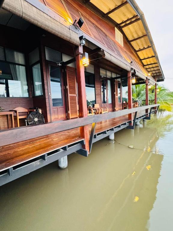 a building sitting on the water in the water at Little Bangkoknoi in Ban Bang Si Thong