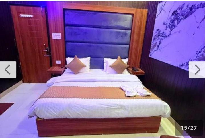 a bedroom with a large bed with white sheets at Hotel moon in Pāonta Sāhib