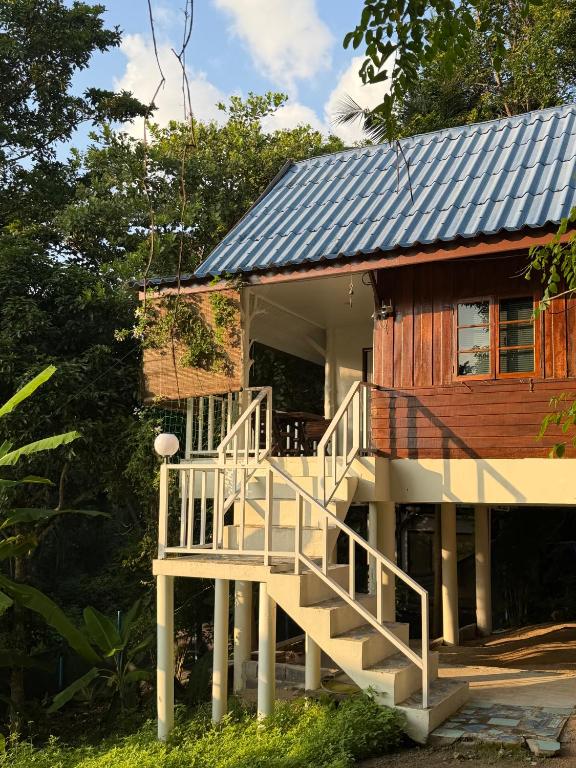 a house with a staircase leading up to it at Simple Cozy House Coconut Lane in Hinkong