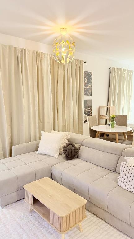 a living room with a couch and a chandelier at Apartment in Leipzig in Leipzig