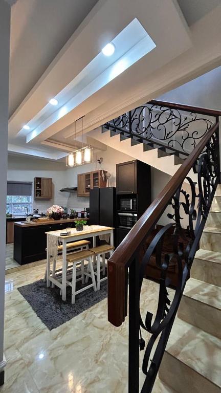 a staircase leading to a kitchen and a living room at Villa Bali Rice Field in Sukaraja