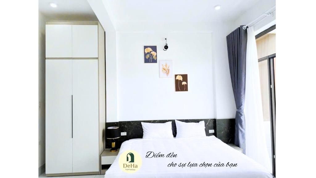 a bedroom with a white bed with a sign on it at DeHa Homestay in Hue