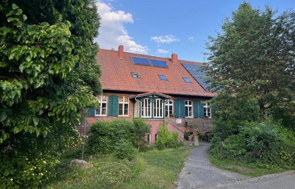 a brick house with a red roof and windows at Forsthaus Neudorf - Eschenblick in Harzgerode