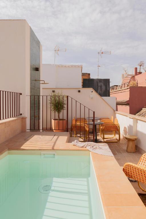 a swimming pool on the roof of a building at LIRIUM Casa Patio in Seville