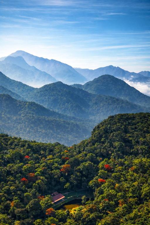 a view of a valley with mountains in the background at Jungle Park Resort-Rain Forest Experience by GreenEscapes in Vythiri
