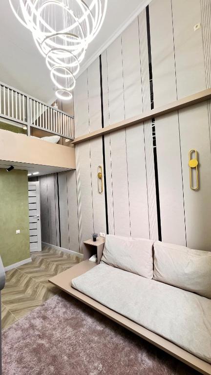 a room with a bed and a chandelier at Лофт отель 11eleven in Shymkent