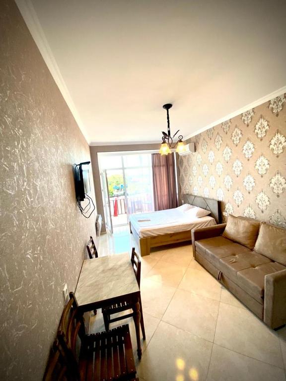 a living room with a couch and a bed at Apartamenti Panorama in Kobuleti