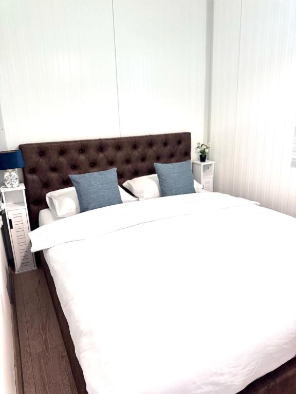 two beds in a room with a large bed at The blue lagoon in Ohrid