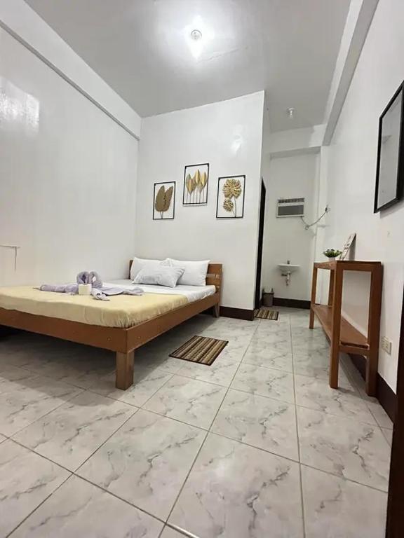 a bedroom with a bed in a white room at Dodong homestay 2 in General Luna