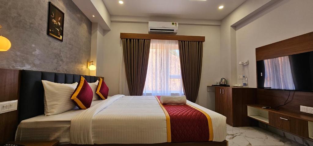 a hotel room with a bed and a window at Royal Palace in Chāvasseri