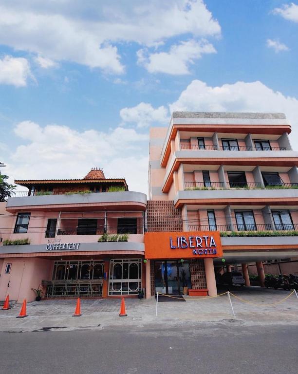 a large building with orange cones in front of it at Liberta Malioboro North in Yogyakarta