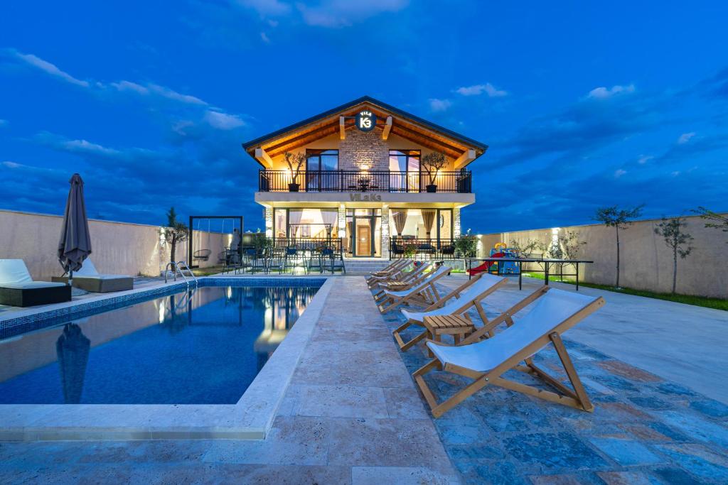 a villa with a swimming pool and a house at VILA K3 Podgorica in Podgorica