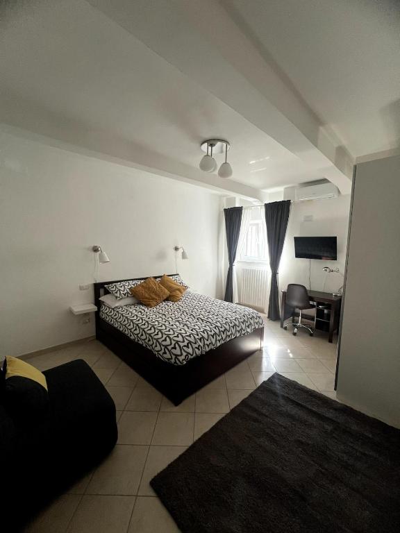 a bedroom with a bed and a desk in it at Casa Paoli in Salerno