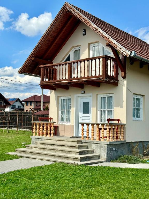 a small house with a balcony on top of it at Casuta-Maria-Kisház in Sovata