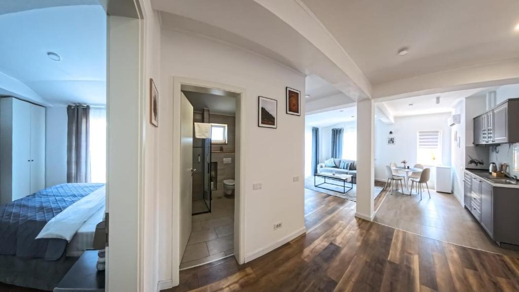 a bedroom with a bed and a living room at Pera Apartments in Cristian