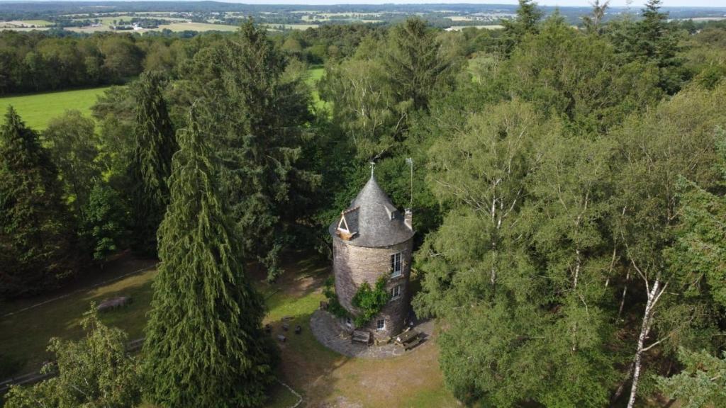 an aerial view of an old castle in the trees at Le Moulin de Bréhaut in Augan