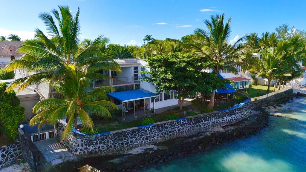 an aerial view of a house next to the water at Rooms on ocean view in Grand-Baie
