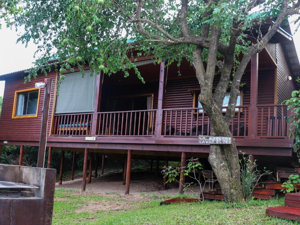 a large wooden house with a large deck at Nhucha Villas in Santa Maria