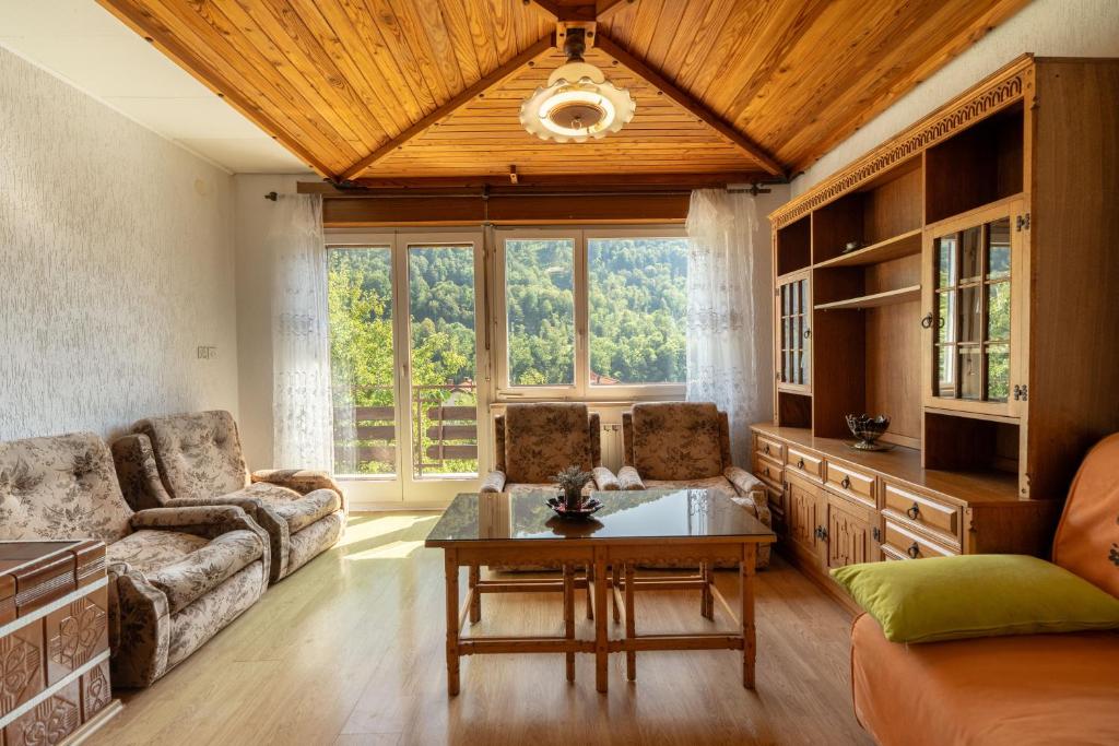 a living room with a couch and a table at Apartmaji Loretica in Most na Soči