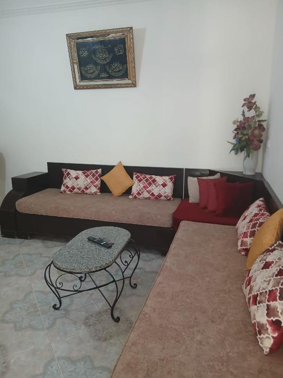 a living room with a couch and a table at Dar Si Lamin in Kelibia