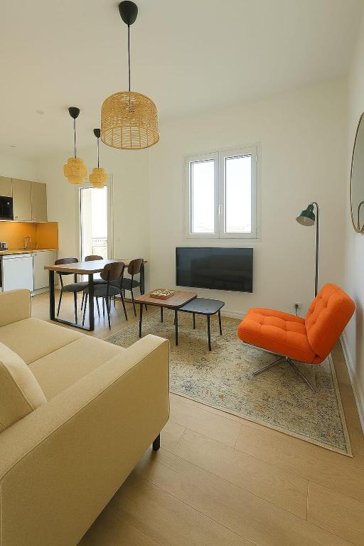 a living room with a couch and a table at La Tour d'Harfleur 2 in Caudebec-en-Caux